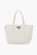 The Tnuck Sport tote is a plain off-white canvas tennis racket bag with two handles and an embroidered green tennis rackets logo on the front.