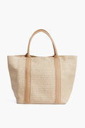 The Urban Expressions large woven straw tote features two handles and tan vertical trim—a chic vegan handbag perfect for everyday use or as a stylish beach bag.
