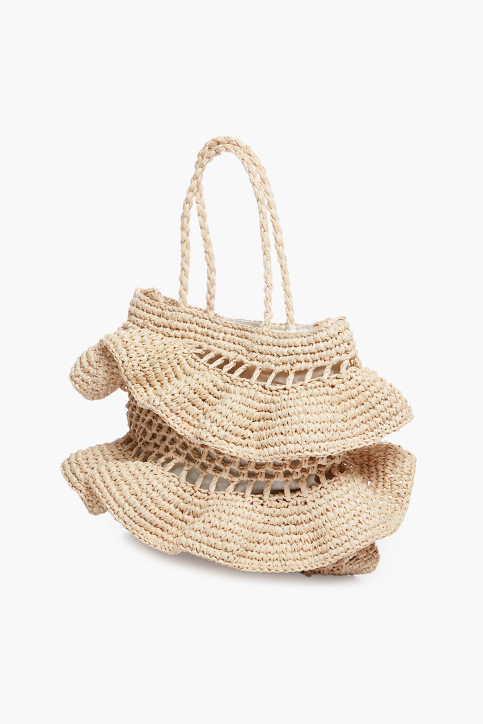 The Hat Attack beige woven raffia bag features layered ruffled detailing and two braided handles—a chic accessory for any look.
