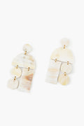 Sunshine Tienda’s lightweight earrings feature cream and beige marbled geometric shapes linked by gold-toned connectors in a cruelty-free, horn dangle design.