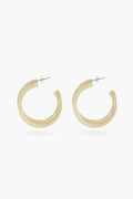 Sunshine Tienda offers translucent, light beige buffalo horn hoop earrings with metal posts, featuring a cruelty-free and elegant design.