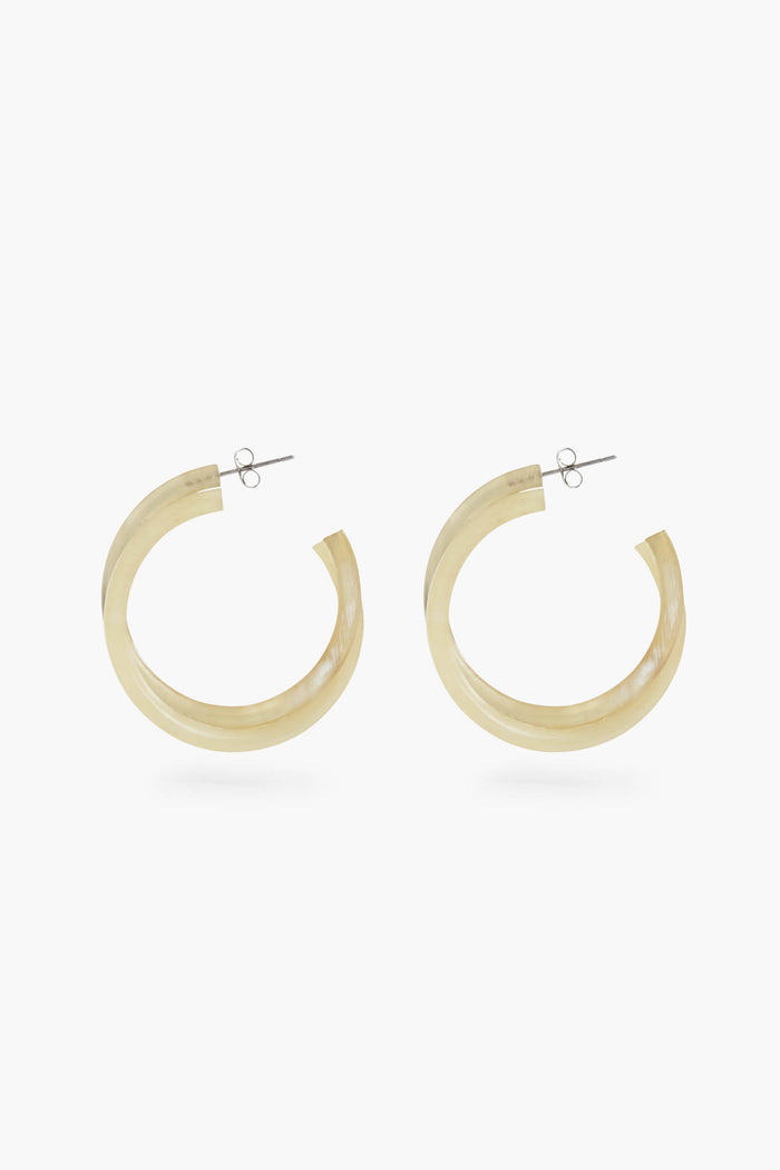 Sunshine Tienda offers translucent, light beige buffalo horn hoop earrings with metal posts, featuring a cruelty-free and elegant design.