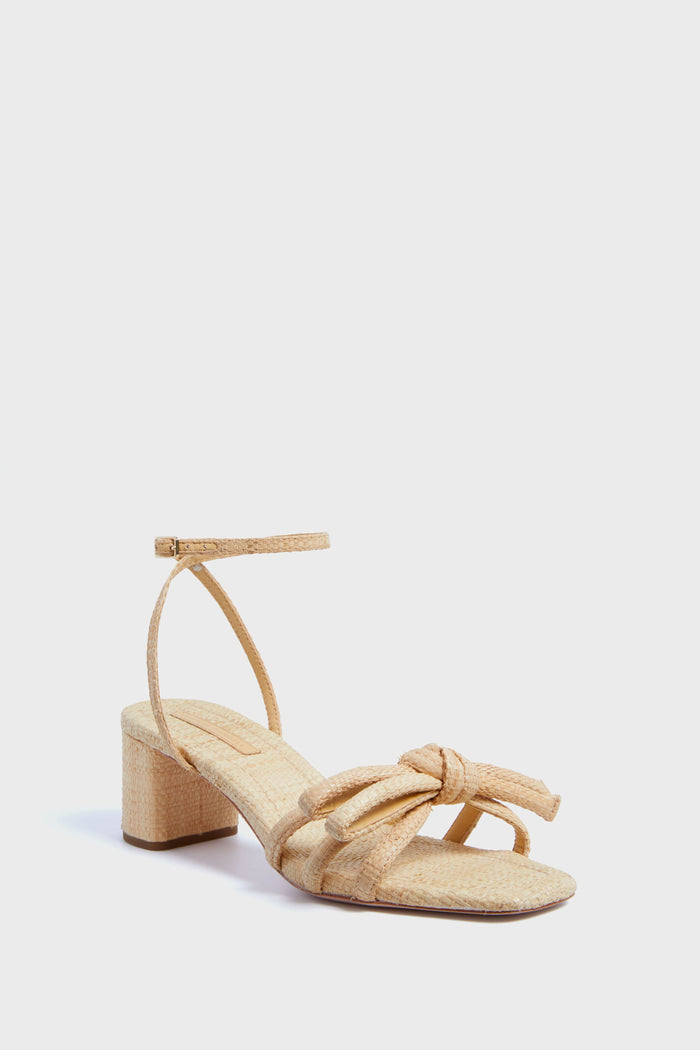 Loeffler Randall beige natural raffia sandal with a low block heel, ankle strap, and front knotted bow detail.