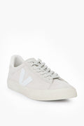 The VEJA white low-top sneaker features light gray laces, a white V logo on the side, and is crafted from organic cotton for an eco-friendly touch.
