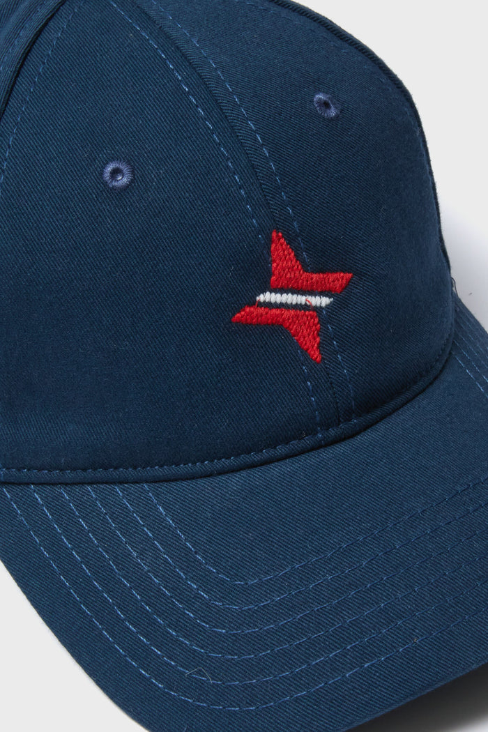 Navy Americana Tuckernuck Hat features a classic, effortless design with a red star embroidery, curved brim, and adjustable sailcloth strap for a fun, high-end look.