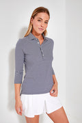 A woman wears a Renwick navy and white striped three-quarter sleeve polo with white shorts, styled as women's golf apparel.
