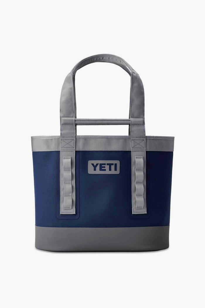 A blue and grey waterproof tote bag from YETI, inspired by the Camino Carryall 35—ideal for your next outdoor adventure.