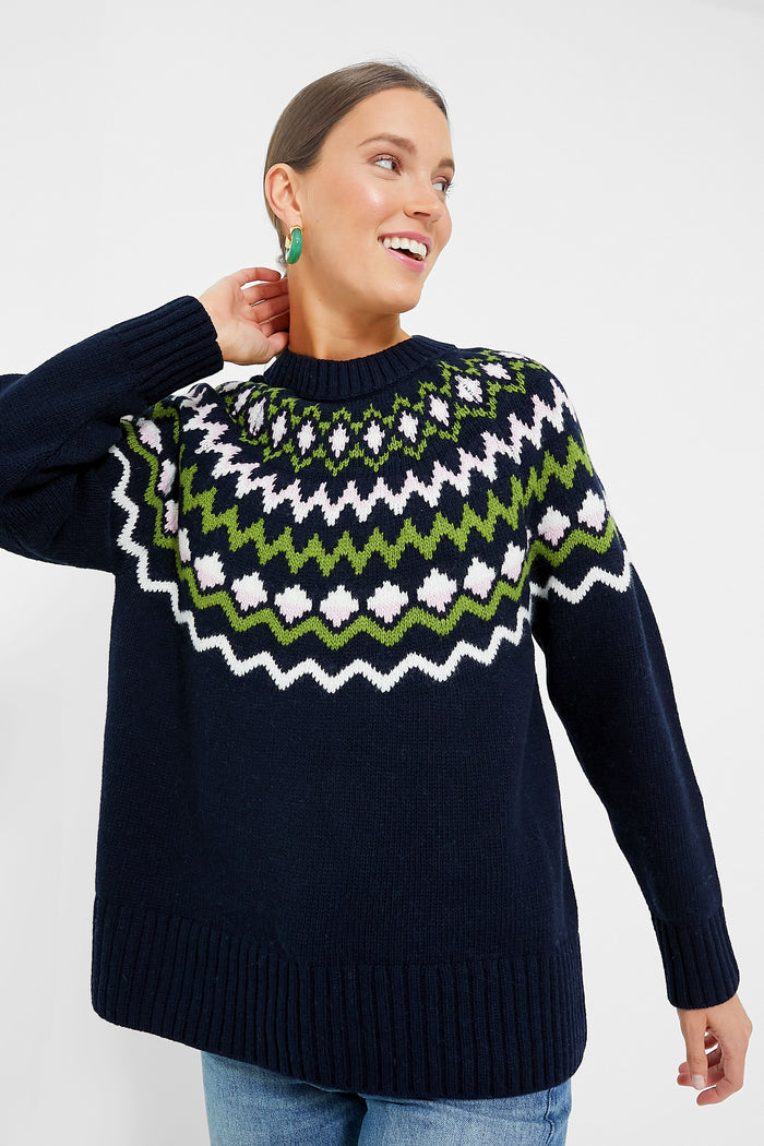 A woman wearing a cozy Barbour Fair Isle sweater.