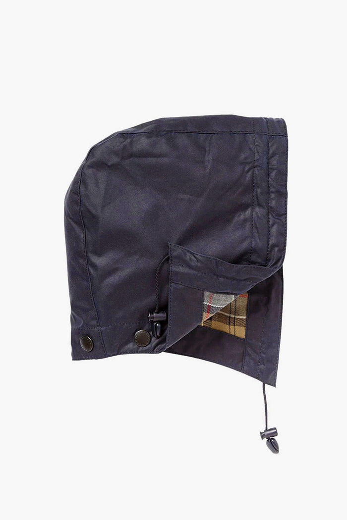 Barbour's detachable dark-colored waxed cotton hood features button and drawstring fasteners, a plaid lining, and is perfect for pairing with Beadnell or Bedale jackets.