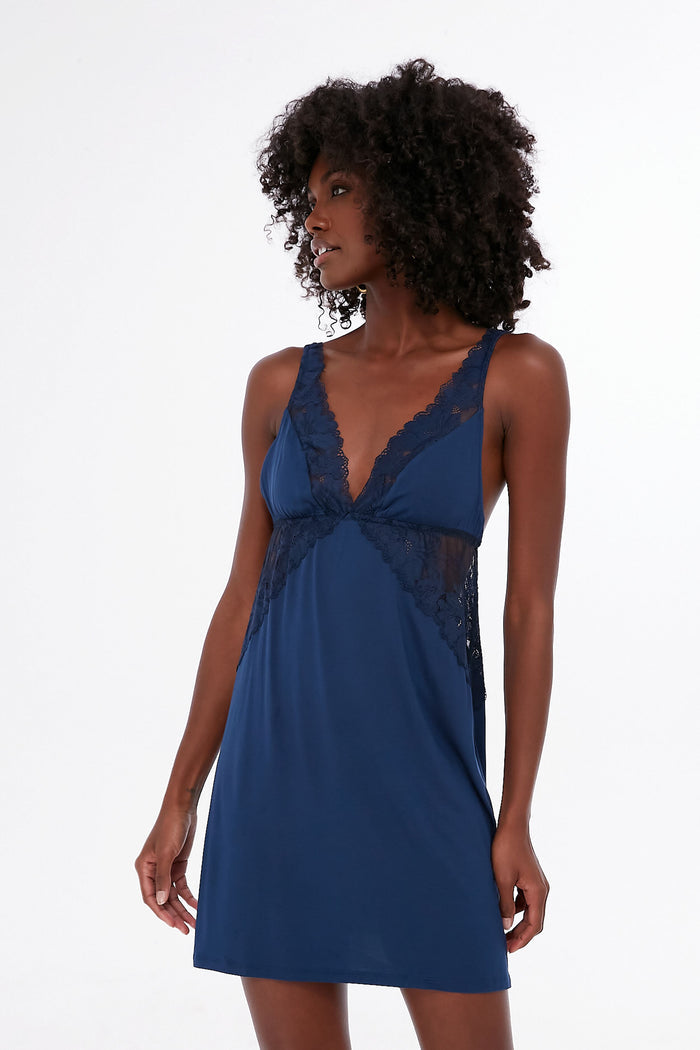 A woman wears an Eberjey navy blue lace-trimmed super-soft chemise, showcasing elegant women's sleepwear.