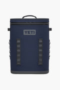 The YETI Hopper BackFlip is a navy blue backpack cooler featuring a top handle, front zipper, side loops, and the YETI logo. Designed by YETI for portability and durability, this leakproof cooler is perfect for on-the-go use.