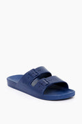 Freedom Moses offers blue vegan women’s slides featuring two adjustable buckle straps and a textured footbed for style and comfort.