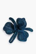 Dark blue woven flower by Coro Cora, handcrafted from rattan/Iraca Palm with three petals and two loops. A stunning Colombian artisan accessory, ideal as a handmade napkin ring.