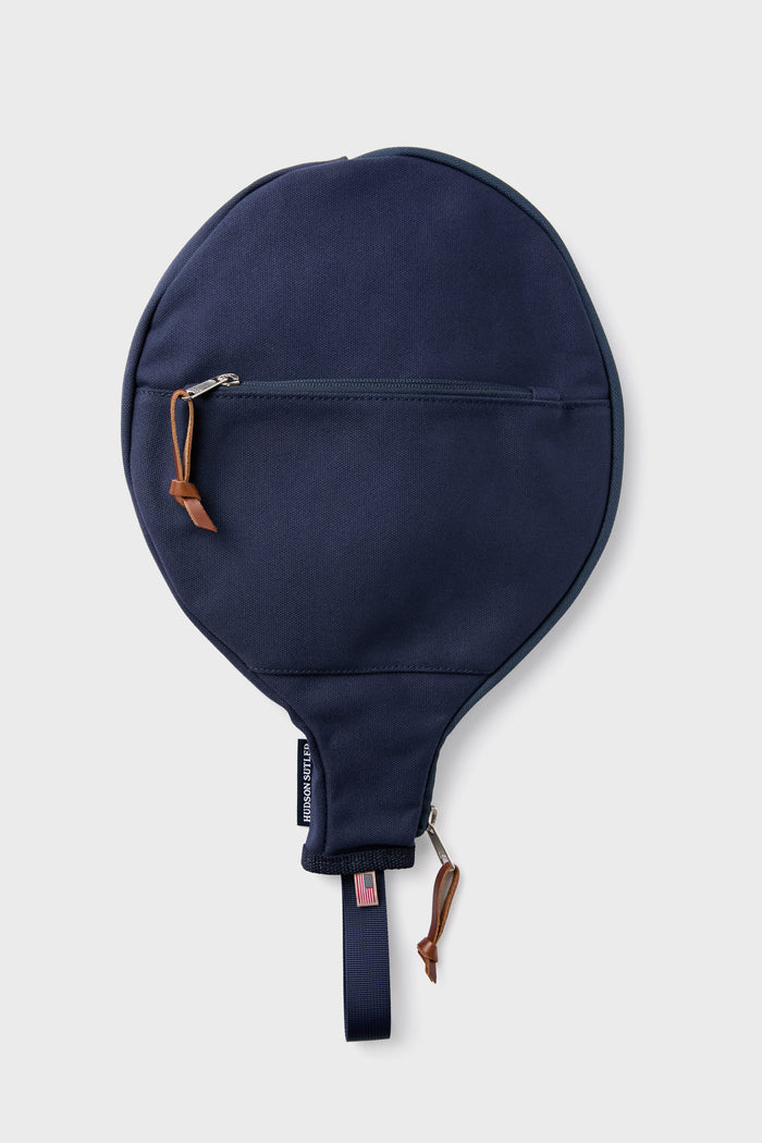 A navy blue round zippered case from Hudson Sutler, featuring a small leather pull. It resembles a paddle racquet cover and is perfect for customizable bags.