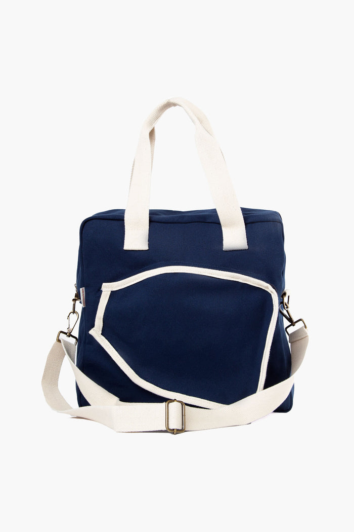 The CB Station navy blue canvas duffel bag features white handles, a white adjustable shoulder strap, and a front zippered pocket with white trim—ideal as a personalized tote or monogrammed gift.