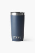 A navy blue YETI Rambler Tumbler with a stainless steel rim and clear lid, featuring the YETI logo. The vacuum-insulated cup keeps beverages at the ideal temperature.