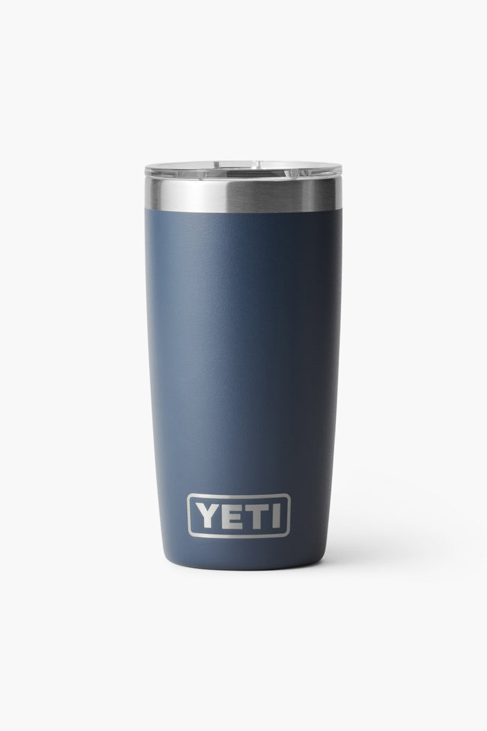 A navy blue YETI Rambler Tumbler with a stainless steel rim and clear lid, featuring the YETI logo. The vacuum-insulated cup keeps beverages at the ideal temperature.