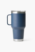 The YETI Rambler Tumbler is a navy blue travel mug with a handle, stainless steel rim and base, and double-wall vacuum insulation.