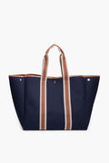 The Rue de Verneuil large navy blue flannel tote bag features brown and white striped handles. Made in France, it's ideal for those seeking luxury luggage.