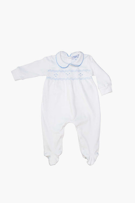 White baby boy footie by Nella Pima, made from soft Peruvian Pima cotton with long sleeves, footed legs, light blue trim, and decorative stitching across the chest and collar.