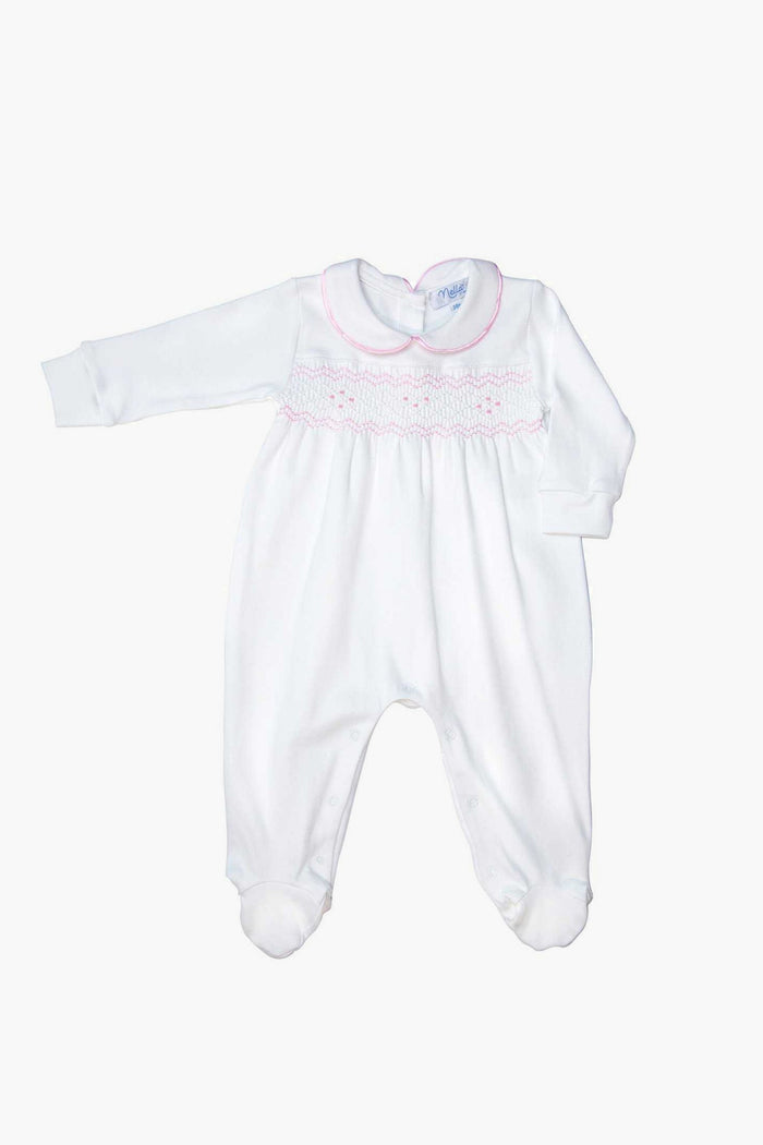 The Nella Pima baby girl footie features soft Peruvian Pima cotton, white long sleeves, footed bottoms, pink collar trim, and pink smocking across the chest.