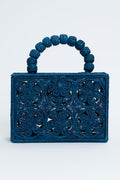 ASHA x Tuckernuck rectangular blue floral clutch with intricate cutout pattern and a handle of large woven beads—perfect for the beach.