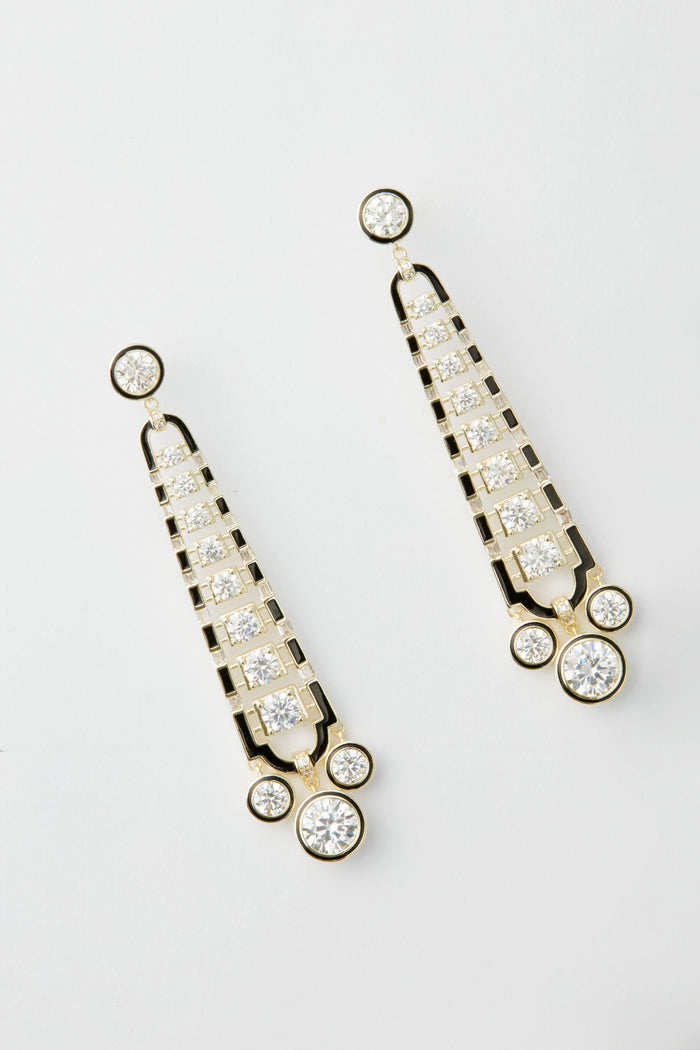 A pair of gold and black art deco earrings by Nicola Bathie, featuring multiple round and square clear gemstones arranged in a symmetrical, vintage-inspired design.