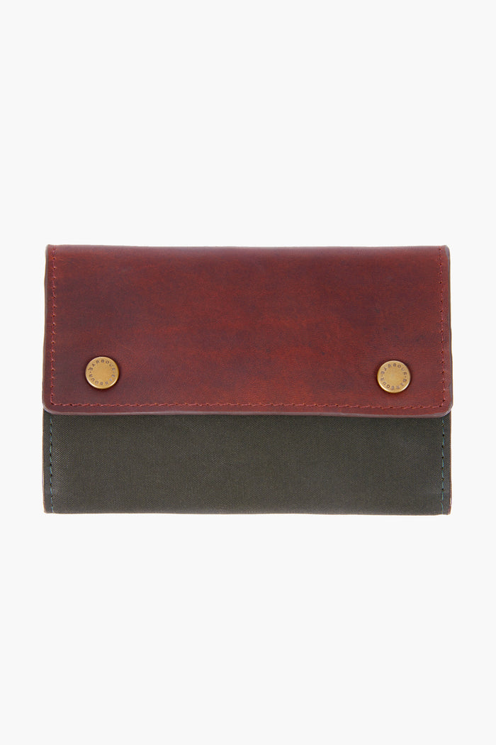The Barbour two-tone leather wallet, with a brown flap, brass snap buttons, and dark green body, is perfect for storing essentials like a Barbour manicure kit or travel grooming set.