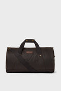 A Barbour duffle bag in dark brown featuring dual handles, a detachable shoulder strap, and a front pocket—ideal for weekend getaways.
