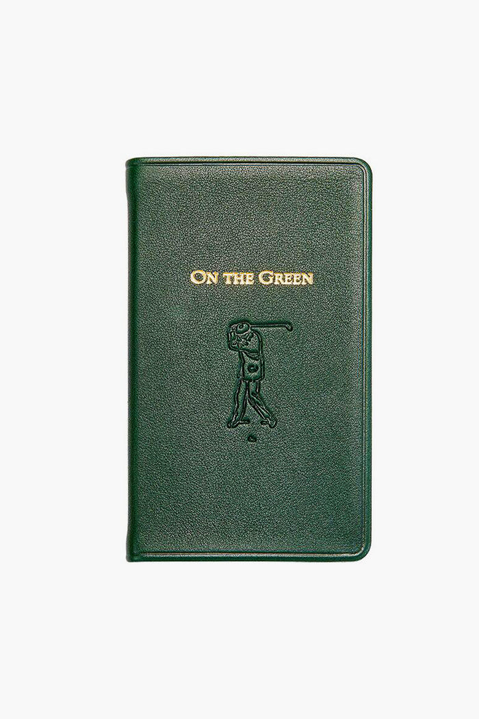 A dark green leather golf scorebook by Graphic Image, featuring "ON THE GREEN" embossed in gold and a golfer swinging a club on the cover—a perfect gift for golf enthusiasts.