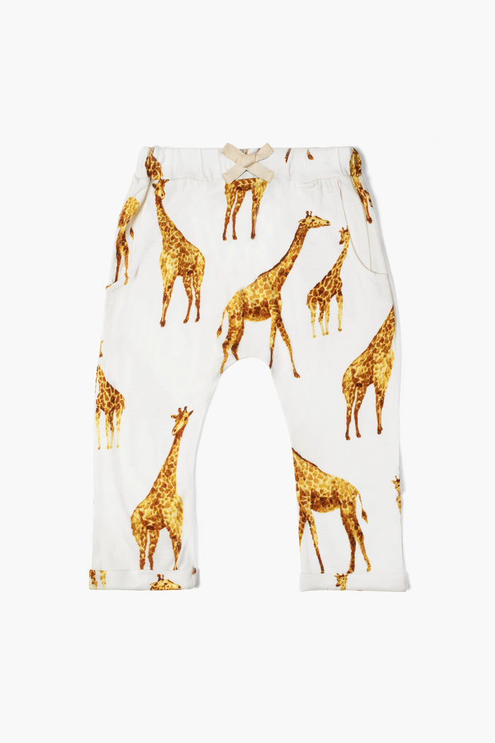 Milkbarn children's jogger pants in white, featuring a soft fabric and an all-over yellow and brown giraffe print for cozy comfort.