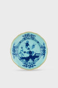 A round porcelain salad plate by Ginori 1735, handcrafted in Italy, featuring Oriente Italiano Iris dark blue floral and landscape patterns with a gold-rimmed edge.