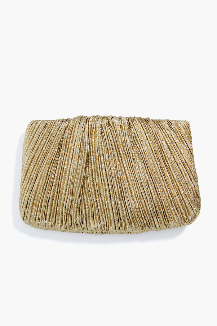 A Loeffler Randall Oro Brit Pleated Clutch is showcased, featuring a shimmering gold Italian lamé finish.