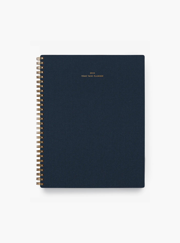 An APPOINTED navy blue cotton-blend bookcloth 2023 yearly task planner with gold cover lettering is centered.