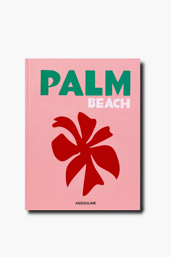 A pink Assouline book cover features "PALM BEACH" in green and white text, a bold red flower graphic, and the brand name Assouline at the bottom.