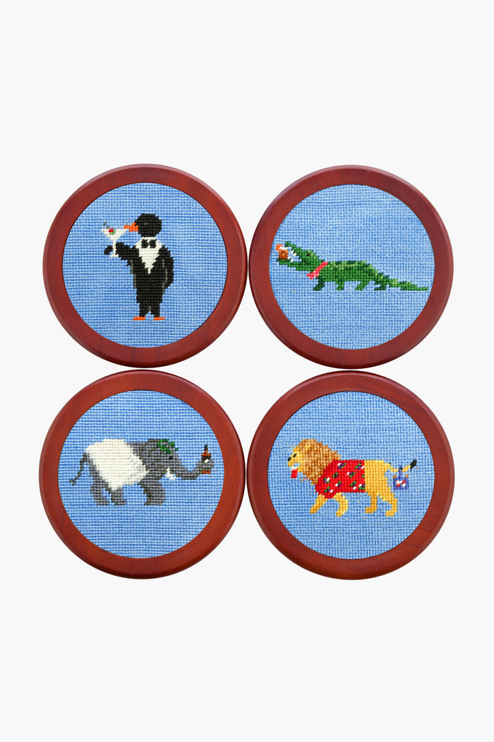 Smathers and Branson’s round needlepoint coasters feature cross-stitched penguin, crocodile, elephant, and lion in Santa hats with brown borders—the perfect festive party animals set for holiday gatherings.