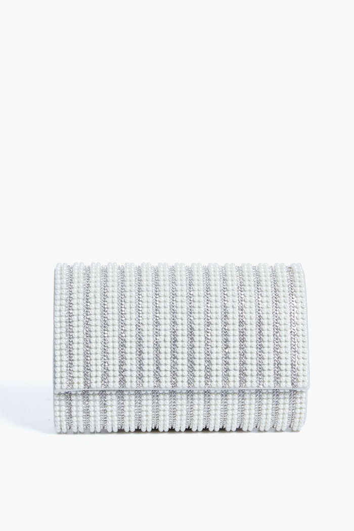 The Olga Berg rectangular silver clutch features a textured ribbed design, flap closure, and crystal embellishments, making it perfect for special occasions.
