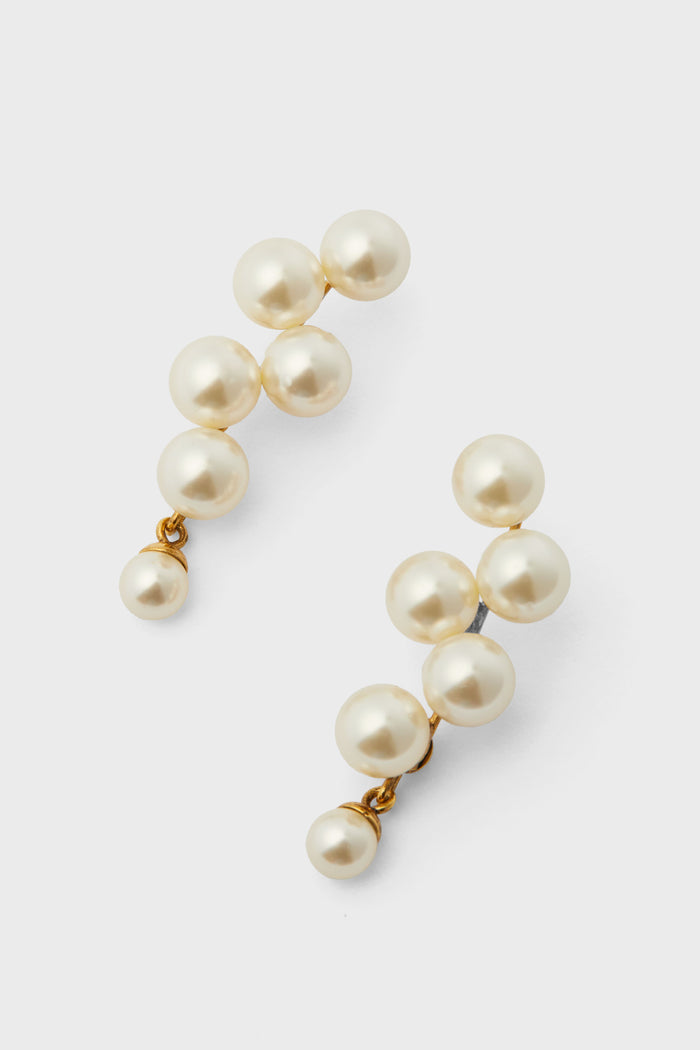 A pair of luxury Jennifer Behr earrings handmade in New York, featuring clusters of round white pearls in a cascading design on gold-plated settings.