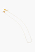 The Tuckernuck Accessories beaded eyeglass or sunglass chain features small white pearls and gold clasps on each end, offering a touch of elegance to your look.