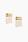 Cult Gaia gold-toned earrings featuring three dangling strands of round freshwater pearls, accented with elegant gold hardware.