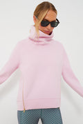 A woman wearing Addison Bay sunglasses and a pink pullover.