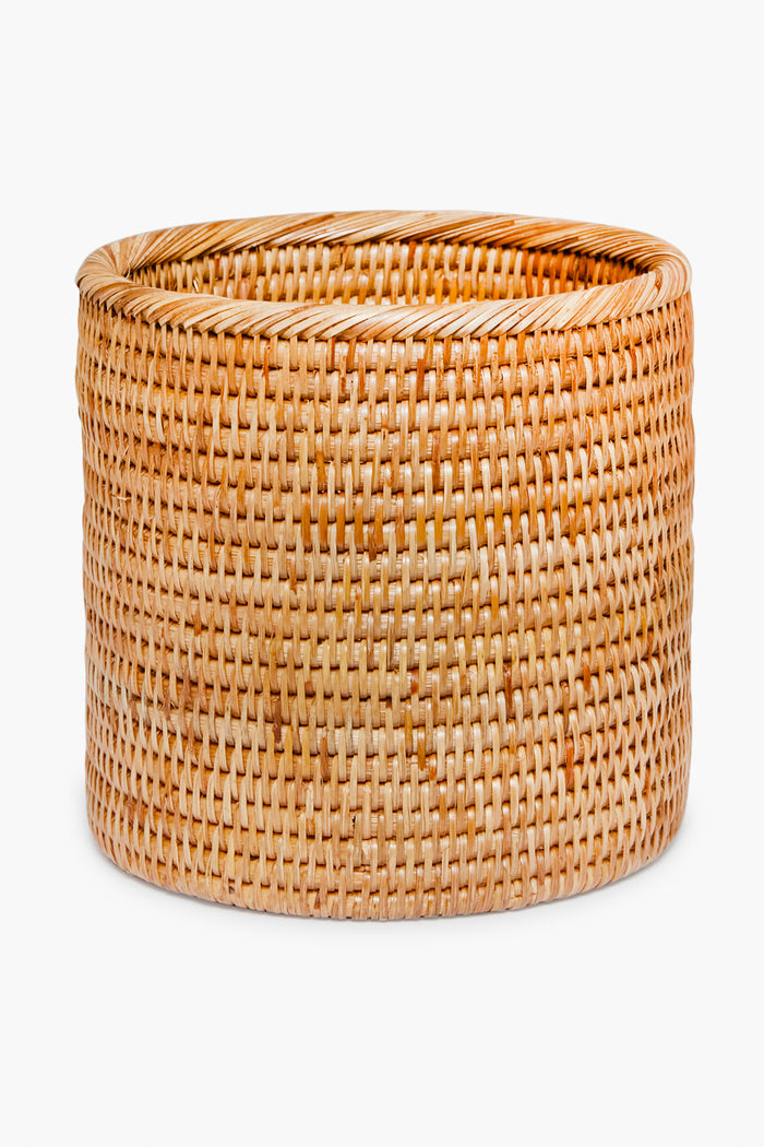 The Artifacts Trading Company round, hand-woven rattan basket in natural light brown adds a beautiful, eco-friendly touch to any home décor.