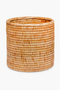 The Artifacts Trading Company round, hand-woven rattan basket in natural light brown adds a beautiful, eco-friendly touch to any home décor.