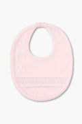 The kissy kissy light pink hand-smocked baby bib features a snap closure, delicate front detailing, and is crafted from soft pima cotton.