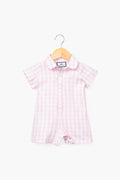 A Petite Plume short-sleeve Pink Infant Gingham Romper with a collar and front buttons, made from luxury cotton sleepwear, is displayed on a wooden hanger.