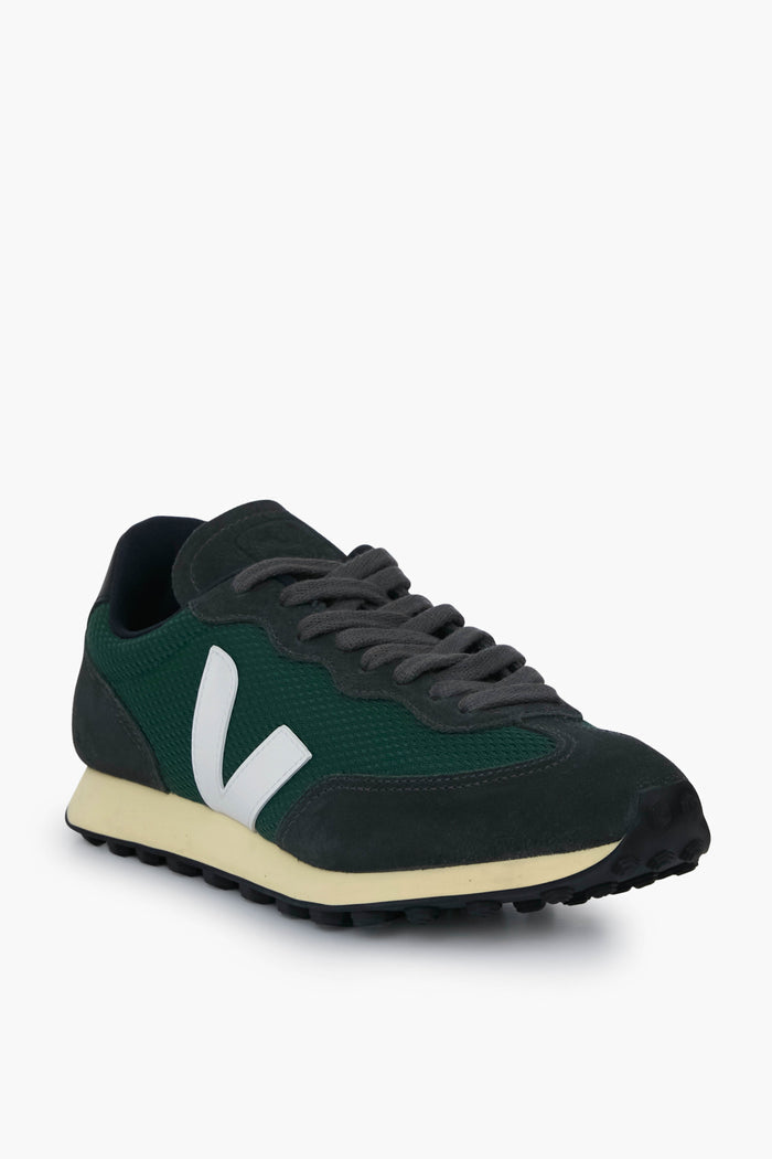 A sustainable VEJA sneaker in dark green and black, featuring a white V logo, gray laces, cream midsole, black outsole—all crafted from recycled materials.