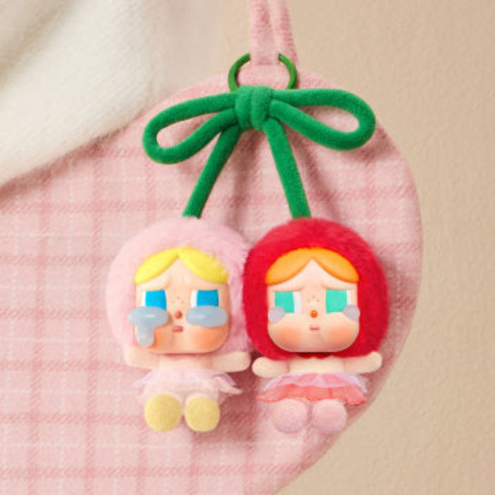Pop Mart Crybaby Cherries figures — two vinyl characters with cherry-themed accents on pink background