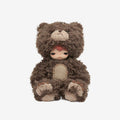 Small doll in a brown bear costume on a white background