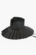 Lorna Murray's black Capri Hat features a pleated woven brim and fabric crown, blending sustainable fashion with UPF 50+ sun protection.