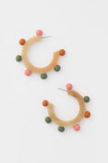 Sunshine Tienda’s lightweight, hand-painted semi-circular hoop earrings feature tan bases and three colorful round beads—pink, green, and orange—adding a vibrant touch to any look.